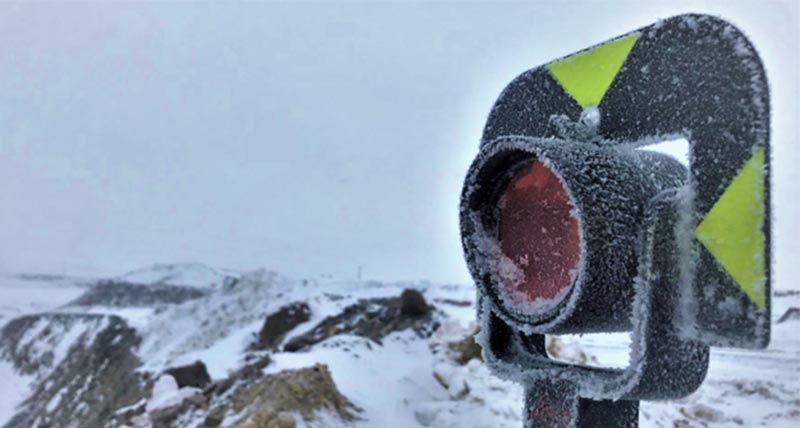 Leica Geosystems prism covered in ice and snow in the mountains